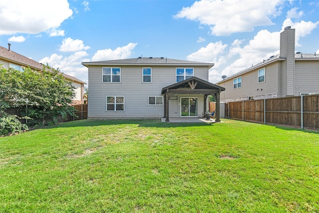 rear view of property with a lawn and a patio