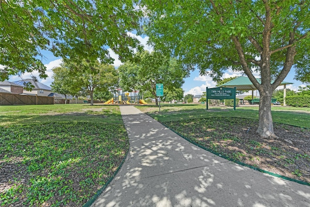 view of community featuring a playground and a lawn