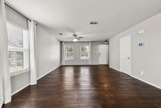 unfurnished living room with dark hardwood / wood-style flooring, a stone fireplace, and sink