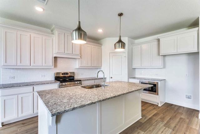 kitchen featuring hardwood / wood-style floors, white cabinetry, sink, and stainless steel appliances