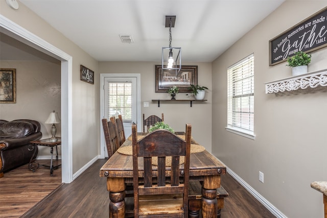 dining area featuring dark wood-type flooring