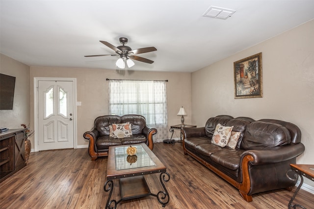 living room with dark hardwood / wood-style floors and ceiling fan