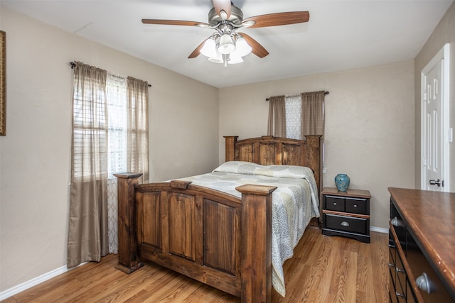 bedroom with light hardwood / wood-style flooring and ceiling fan