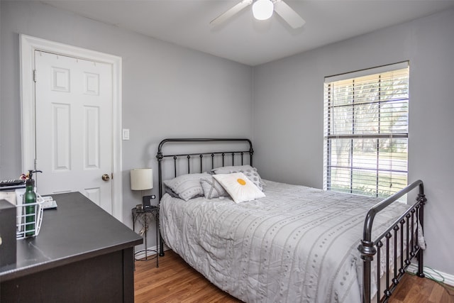 bedroom with ceiling fan and dark wood-type flooring