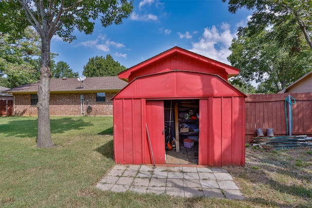 view of outdoor structure featuring a lawn