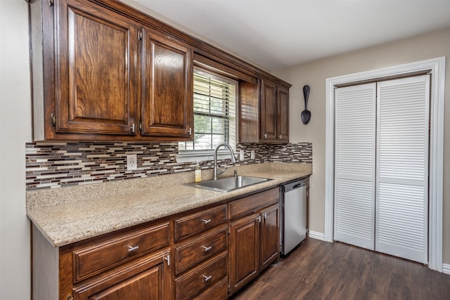 kitchen with dark brown cabinets, tasteful backsplash, sink, dark hardwood / wood-style flooring, and stainless steel dishwasher