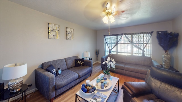 living room featuring hardwood / wood-style floors and ceiling fan