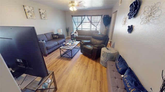 living room with light wood-type flooring and ceiling fan