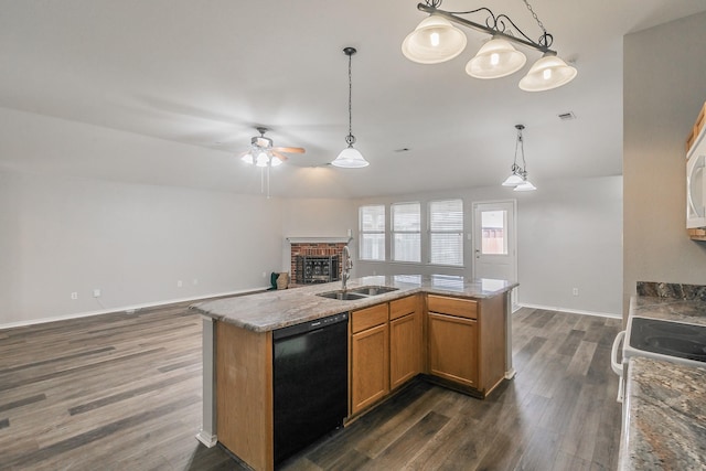 kitchen featuring a fireplace, a center island with sink, hanging light fixtures, open floor plan, and dishwasher