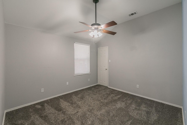 unfurnished room featuring dark colored carpet, lofted ceiling, visible vents, ceiling fan, and baseboards