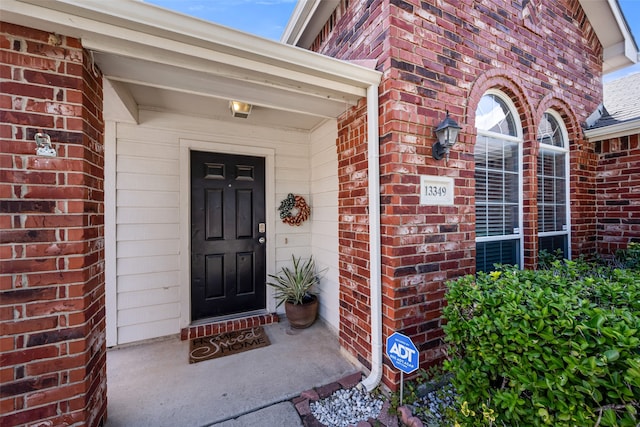 property entrance with brick siding