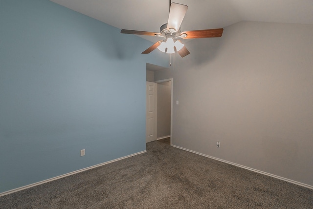 empty room featuring vaulted ceiling, baseboards, dark colored carpet, and a ceiling fan