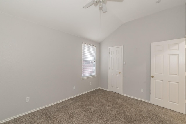 spare room with lofted ceiling, carpet flooring, ceiling fan, and baseboards