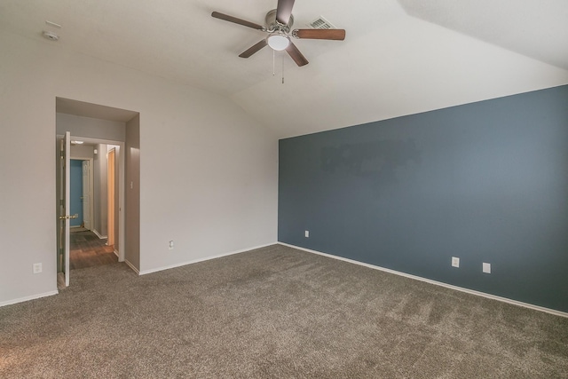 interior space with baseboards, visible vents, lofted ceiling, ceiling fan, and dark colored carpet