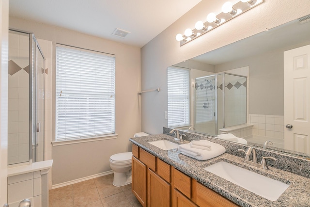 bathroom featuring double vanity, tile patterned flooring, a sink, and a shower stall