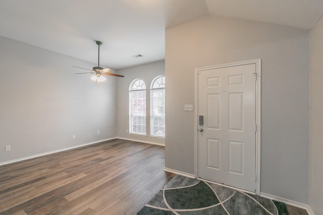 entryway featuring ceiling fan, wood finished floors, visible vents, baseboards, and vaulted ceiling