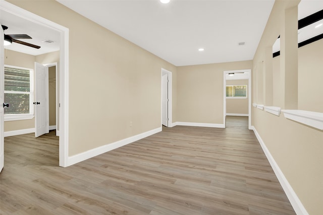 unfurnished room featuring light wood-type flooring and ceiling fan