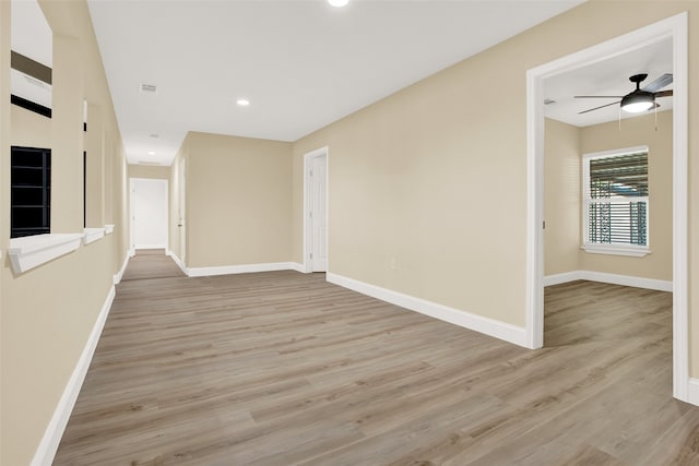 spare room featuring ceiling fan and light hardwood / wood-style flooring