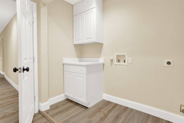 laundry area featuring washer hookup, cabinets, light wood-type flooring, and electric dryer hookup