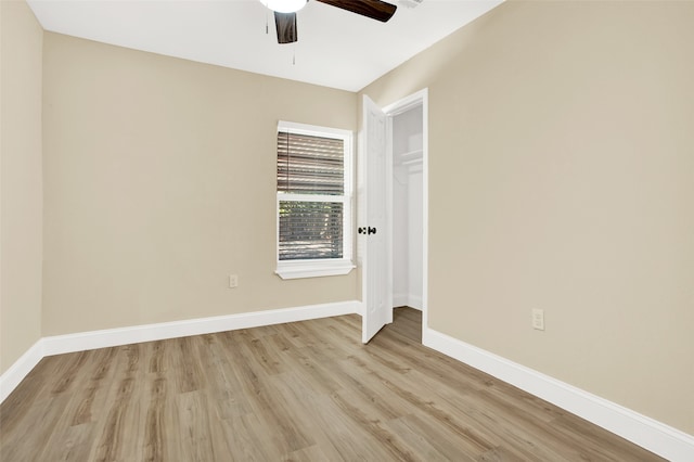 unfurnished bedroom featuring ceiling fan, a closet, and light hardwood / wood-style flooring