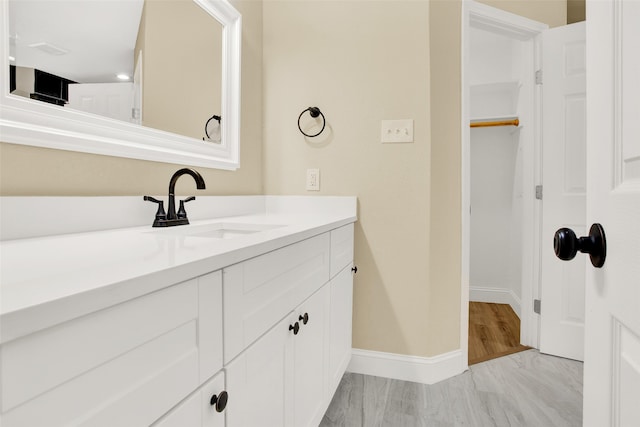 bathroom with vanity and hardwood / wood-style floors