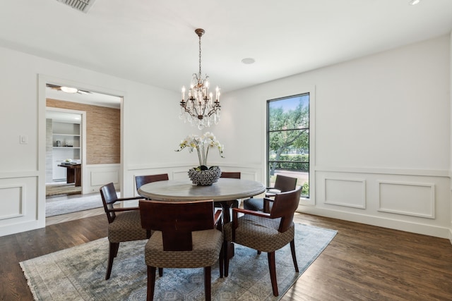 dining room featuring dark hardwood / wood-style floors and a notable chandelier