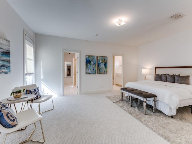 bedroom featuring baseboards, visible vents, ensuite bath, and carpet flooring