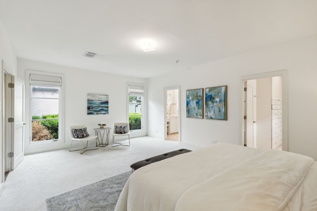 carpeted bedroom with connected bathroom