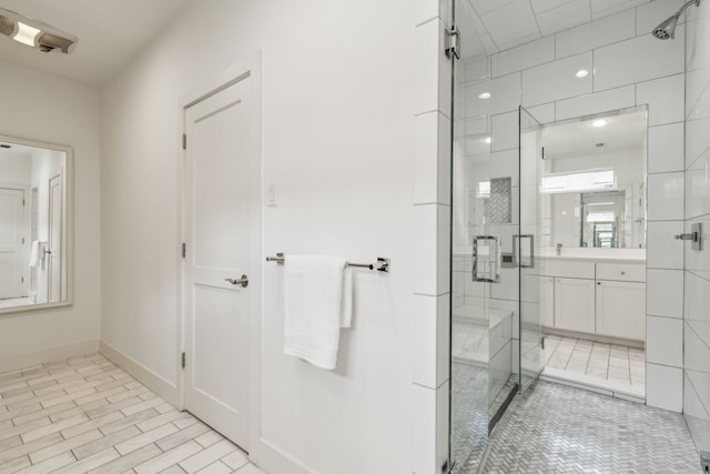 bathroom with vanity and a shower with shower door