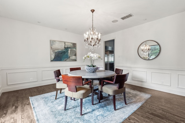 dining room featuring dark hardwood / wood-style floors and a notable chandelier