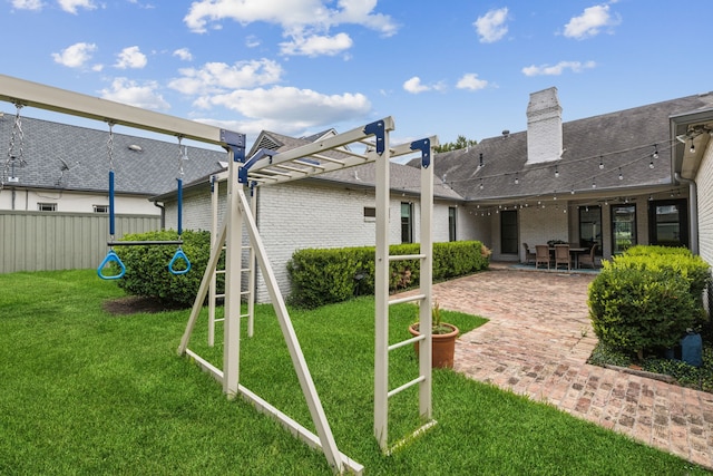 view of jungle gym with a pergola, a patio area, and a lawn