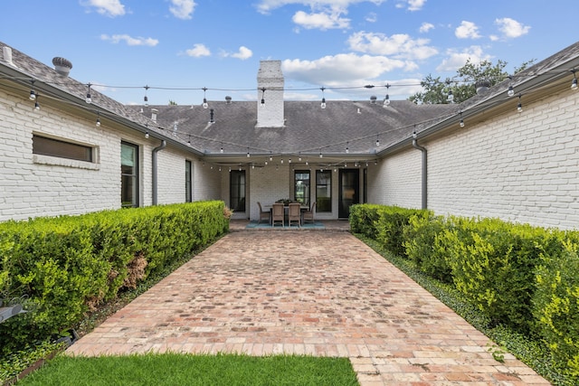 entrance to property featuring a patio area