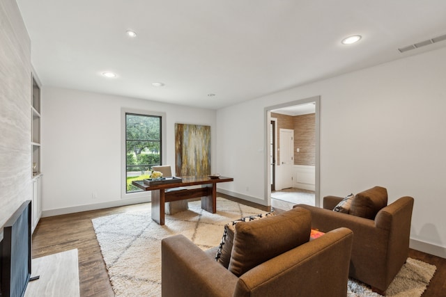 living room featuring light hardwood / wood-style floors and a fireplace