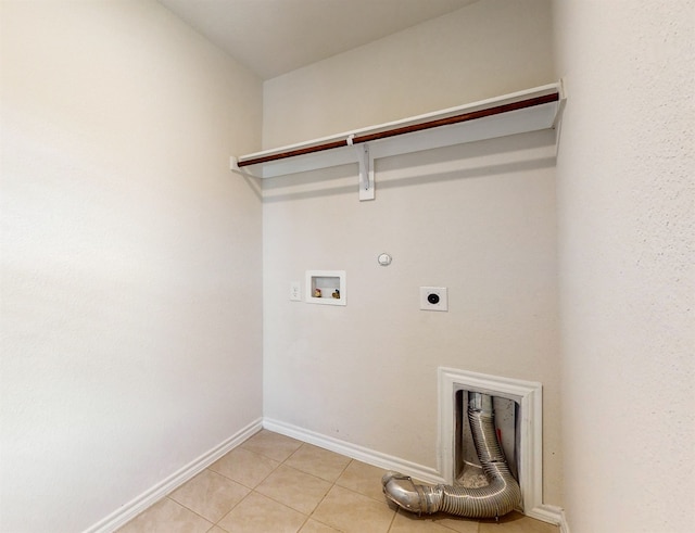 washroom with hookup for a gas dryer, hookup for an electric dryer, hookup for a washing machine, and light tile patterned floors