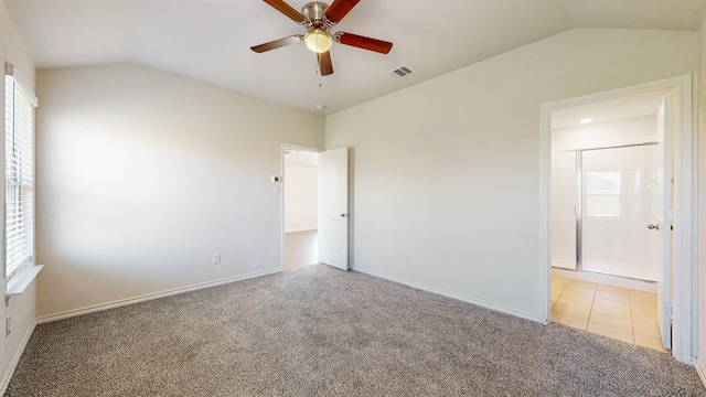 carpeted spare room with vaulted ceiling and ceiling fan