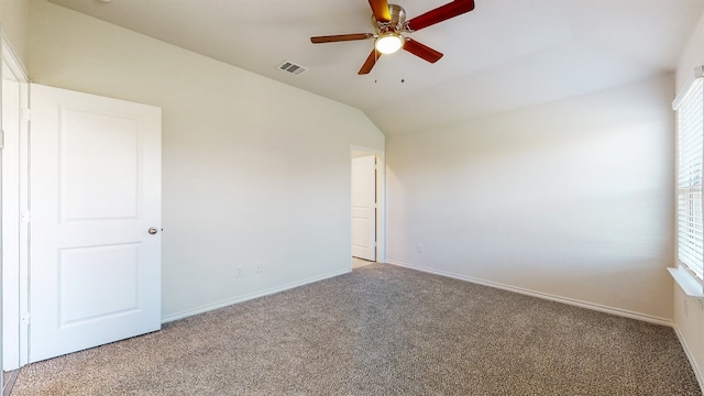 spare room with carpet flooring, plenty of natural light, and vaulted ceiling