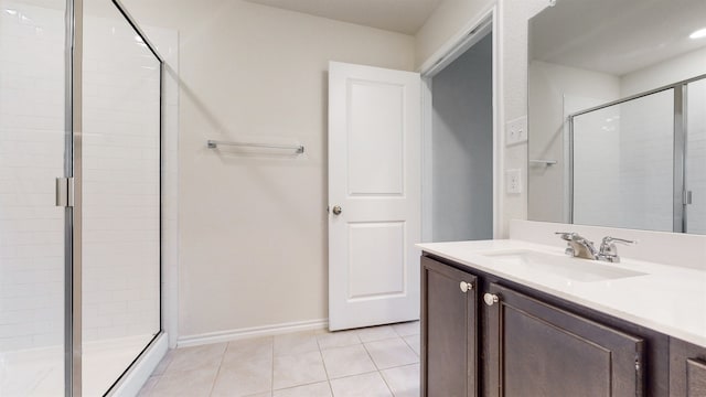 bathroom featuring vanity, tile patterned flooring, and a shower with door