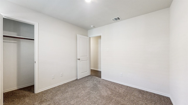 unfurnished bedroom with carpet and a closet