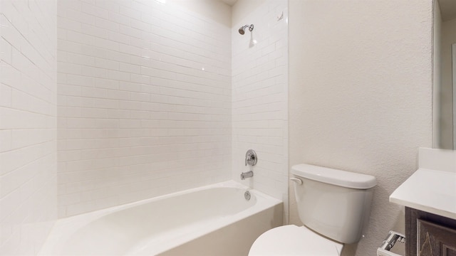 full bathroom with vanity, toilet, and tiled shower / bath