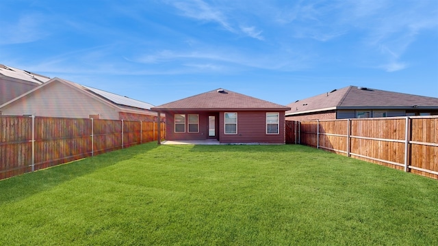 rear view of house with a patio and a lawn