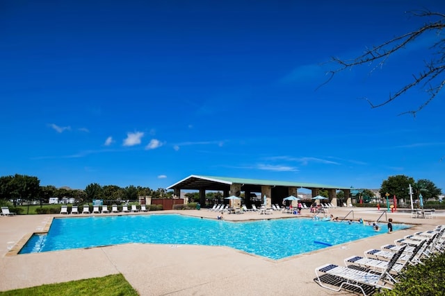 view of swimming pool featuring a patio and a gazebo