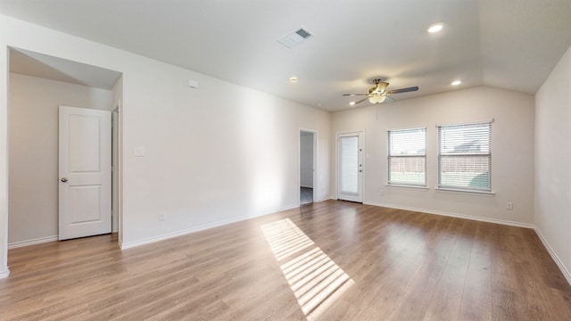 spare room with light hardwood / wood-style flooring, lofted ceiling, and ceiling fan