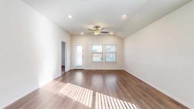 empty room featuring ceiling fan, vaulted ceiling, and dark hardwood / wood-style floors