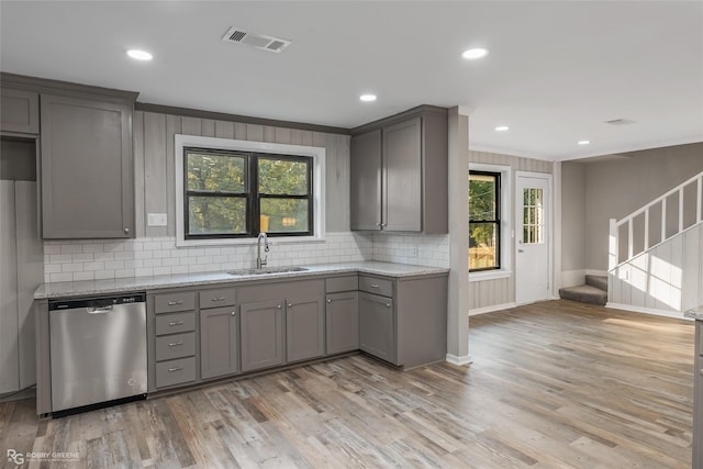 kitchen with stainless steel dishwasher, gray cabinetry, and sink