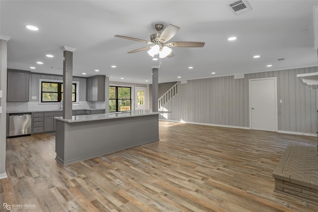 kitchen featuring tasteful backsplash, light stone counters, ceiling fan, dishwasher, and gray cabinets