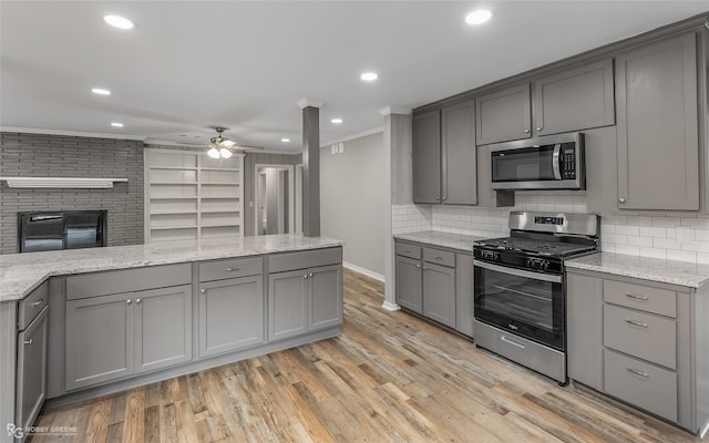 kitchen featuring appliances with stainless steel finishes, light hardwood / wood-style flooring, and gray cabinetry