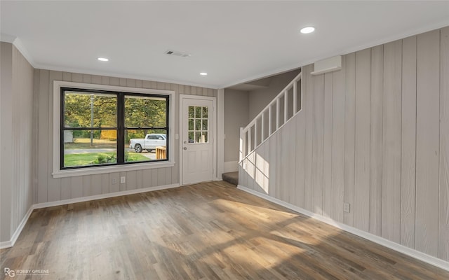 spare room with ornamental molding and hardwood / wood-style flooring