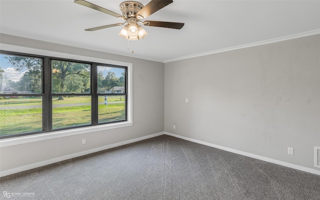 carpeted spare room with ceiling fan and crown molding