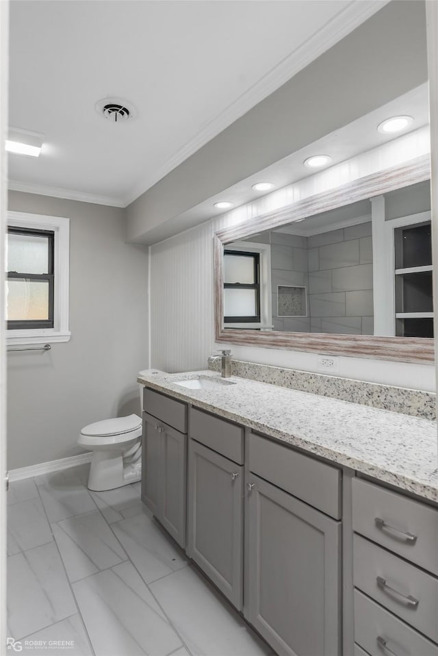 bathroom with vanity, toilet, and ornamental molding