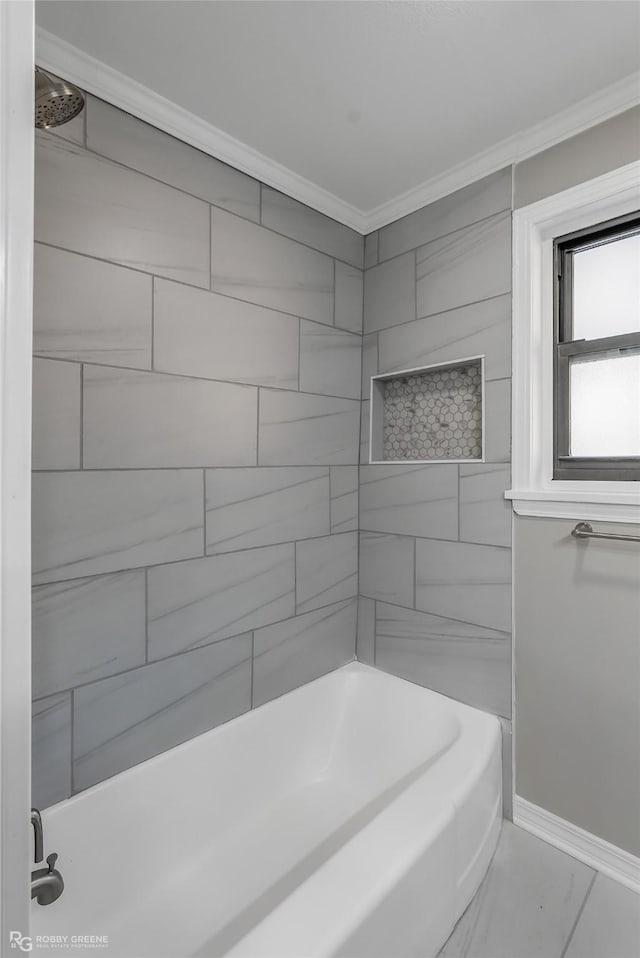 bathroom featuring tiled shower / bath combo and crown molding